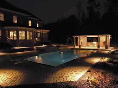 Another well lit pool house/cabana and pool area